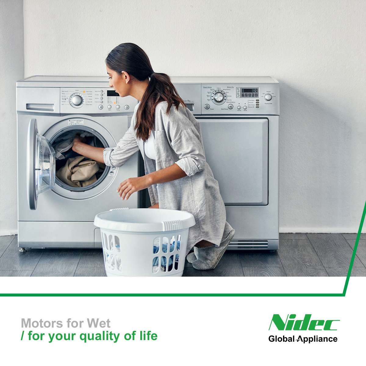 Woman loading a washing machine, motors for Wet for your quality of life