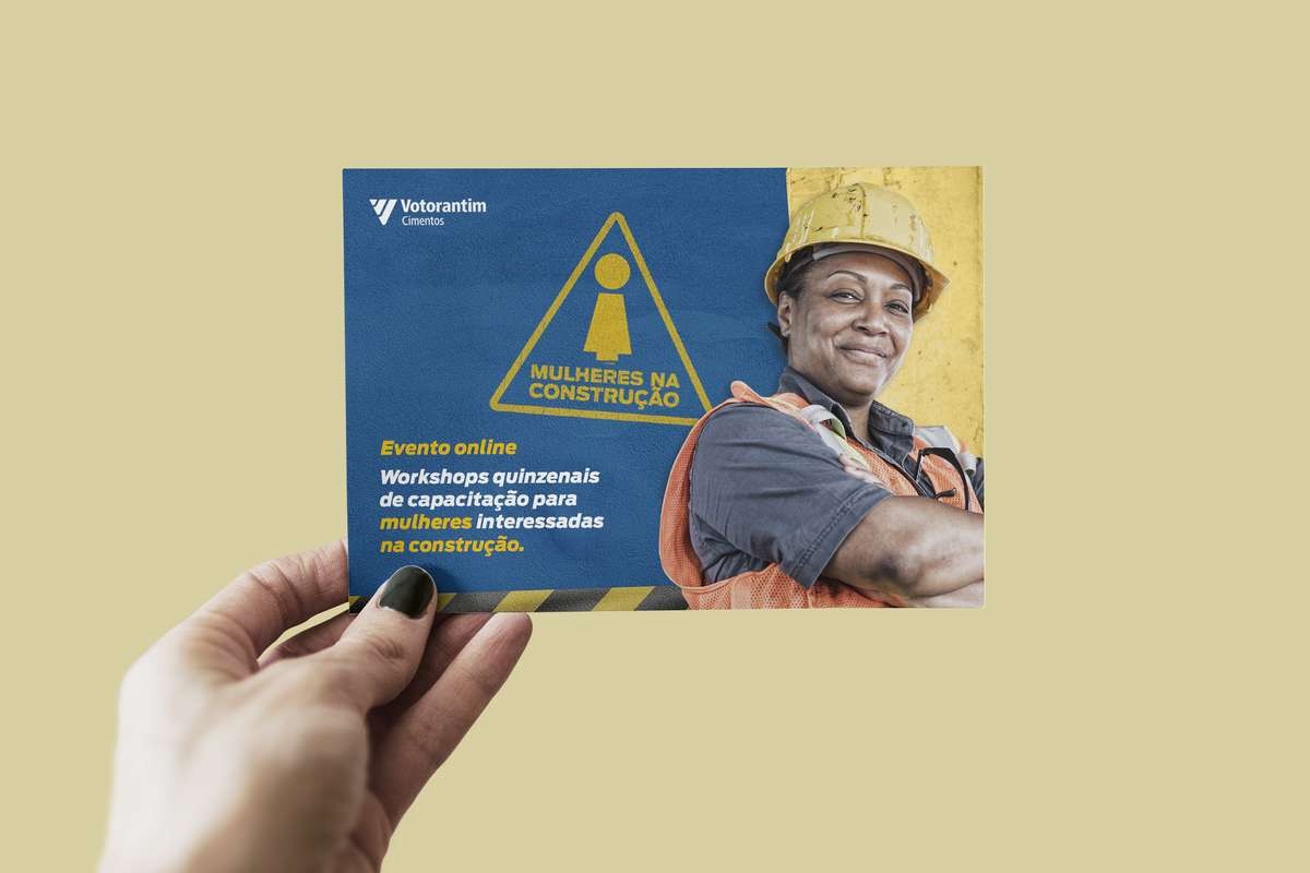 Hand holding a Women in Construction printed card
